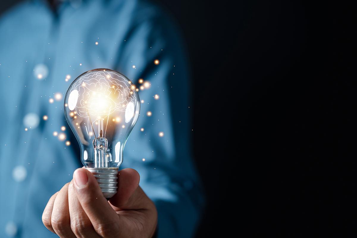 a person holding a bright light bulb